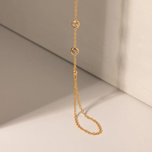 Detail of 18k gold plated stainless steel chain bracelet with sparkling zircon stones