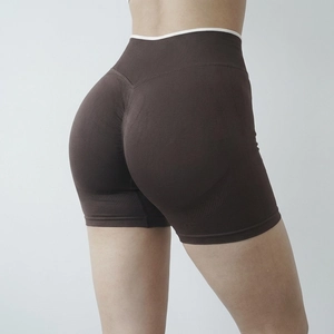Detail of high-waist seamless yoga shorts in brown with scrunch butt lifting effect
