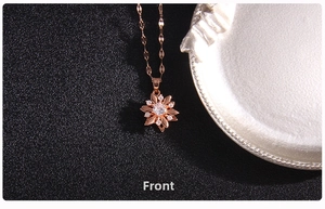 Macro detail of rotating four-leaf clover pendant in rose gold with zircon crystals