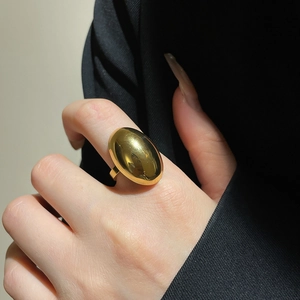 Macro shot of a chunky 18k gold plated stainless steel ring with a drop design