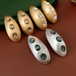 Oval brushed metal stud earrings with sparkling rhinestones in vintage luxury style