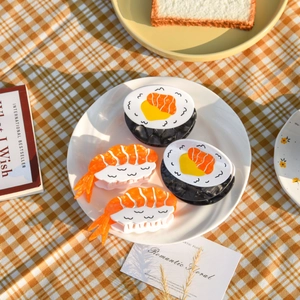 Detailed view of creative acetate sushi hair claws including nigiri and roll designs