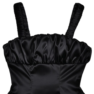 Detailed view of the black satin top showing pleated texture and glossy silk-like finish