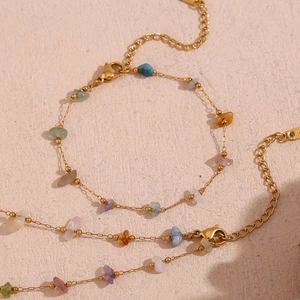 Detailed macro of 18K gold plated chain with colorful natural crushed stone textures