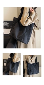 Detail of a large black canvas tote bag with reinforced cross webbing and wide shoulder straps