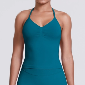 Detail view of teal seamless sports crop top featuring a halter V-neck and ruched chest