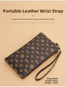 Close-up of vintage floral pattern on brown clutch bag with golden zipper and wristlet