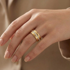 Detailed shot of gold titanium ring with hammered texture and paved zircon stones