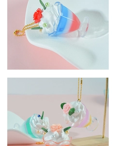 Close-up of cream sundae keychain with colorful faux fruit and rose pendant detail
