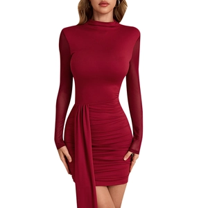 Detail view of burgundy knitted dress featuring mesh sleeves and ruched waist draping