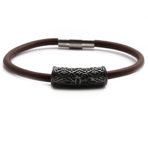 Detail of dark brown braided leather bracelet with vintage magnetic cross clasp