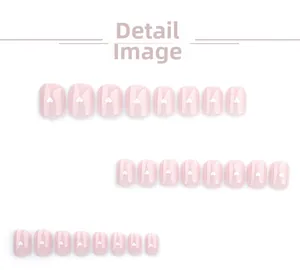 Dettaglio di unghie finte rosa nude con piccoli cuori bianchi in varie dimensioni