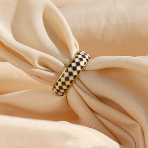 Detail of 18K gold plated ring with black and white checkerboard enamel through silk