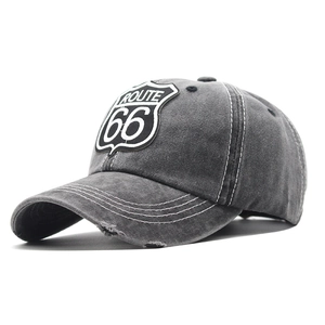 Close-up of vintage Route 66 patch embroidery and distressed brim on gray baseball cap