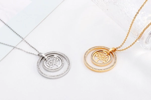 Detail of silver and gold tree of life necklaces with rhinestone circle pendants