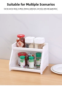 Detail of white 2-tier storage rack organized with kitchen spice jars on a desktop