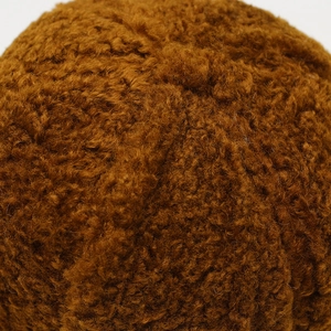 Close-up of the plush brown faux lamb wool texture showing soft and dense fibers