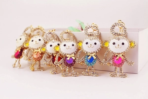 Detailed row of crystal monkey keychains in multiple colors on a clean white display edge