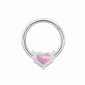 Detail view of silver nose ring featuring a heart-shaped pink opal stone with wings