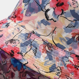Close-up of floral print bucket hat showing precision stitching and fabric texture