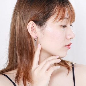 Minimalist silver multi-layer layered circle drop earrings worn by a model