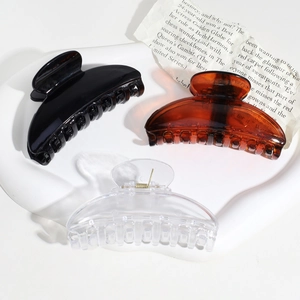 Three semi-circular hair claw clips in black, tortoiseshell, and clear acrylic colors