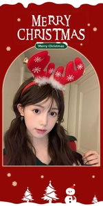 Detail of red Christmas reindeer antler headband with white snowflakes and bells