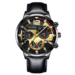 Detailed macro view of the black watch dial featuring golden sub-dials and calendar display