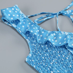 Detail of blue daisy floral dress featuring smocked elastic bodice and ruffle trim straps