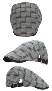 Detail view of grey plaid ivy cap with black contrast brim and metal adjustable buckle