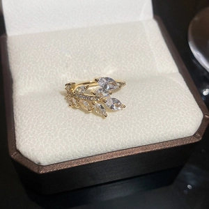 Close-up of 18K gold plated leaf ring with sparkling crystals in a jewelry box