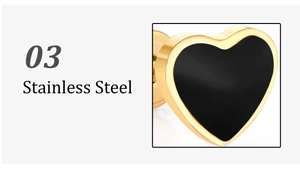 Detailed view of heart-shaped stainless steel earrings with black core and gold borders