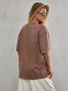 Detail view of oversized retro brown acid wash cotton T-shirt with vintage faded texture