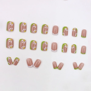 Short square press-on nails with green French tips and white daisy floral patterns