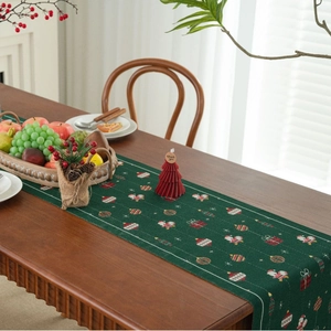 Christmas green jacquard table runner with Santa and gift patterns for festive dining decor