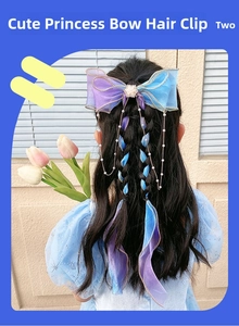 Detail of blue and purple gradient organza hair bow with pearl chains on a girl