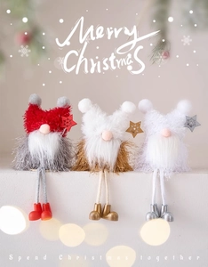Three plush Christmas gnomes with long legs in red, gold, and silver festive knit outfits