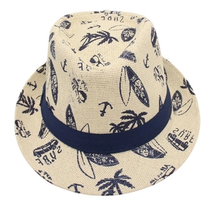 Detail of beige summer fedora with dark blue surf patterns and palm tree motifs