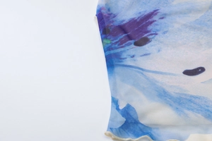 Close-up of blue and purple floral print on semi-transparent mesh fabric detail