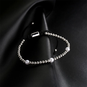 Detail of silver beads and white pearls on black woven cord with adjustable slider