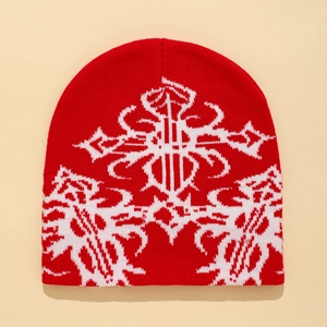 Red knit beanie with white gothic jacquard cross pattern in a stylish streetwear look