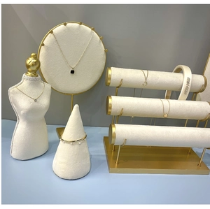 Detailed arrangement of luxury jewelry and white velvet headband on professional stands