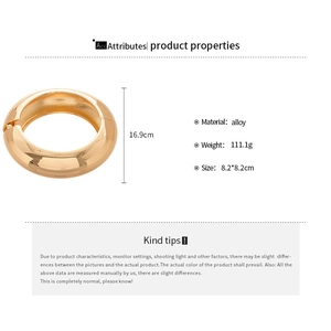 Detailed view of wide metallic gold bangle with dimensions 8.2cm and 111.1g weight