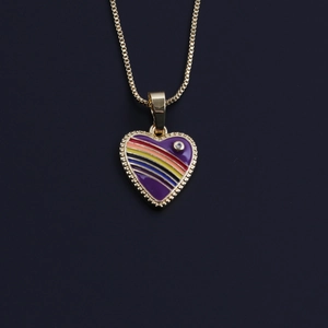 Detailed close-up of golden heart pendant with purple enamel and rainbow stripe patterns