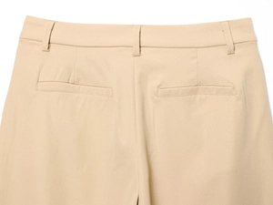 Close-up of khaki trousers featuring reinforced belt loops and neat welt pockets