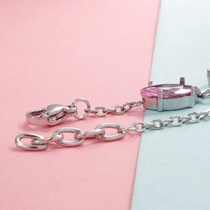 Detail of pink marquise-cut gemstone charm with silver lobster clasp and extension chain