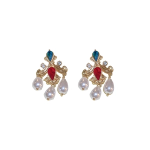 Vintage gold earrings with colorful stones and white pearl drops on white background
