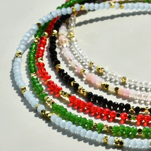 Detailed view of colorful faceted crystal bead necklaces with gold accent spacers