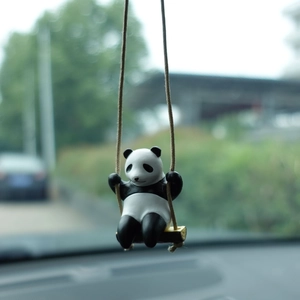 Cute panda swinging on a branch car pendant hanging from the rearview mirror view