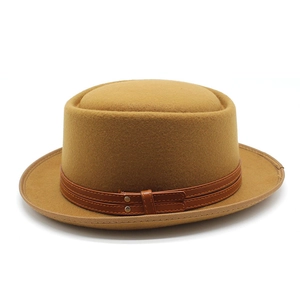 Close-up of camel wool felt hat featuring double leather bands and metal rivet details